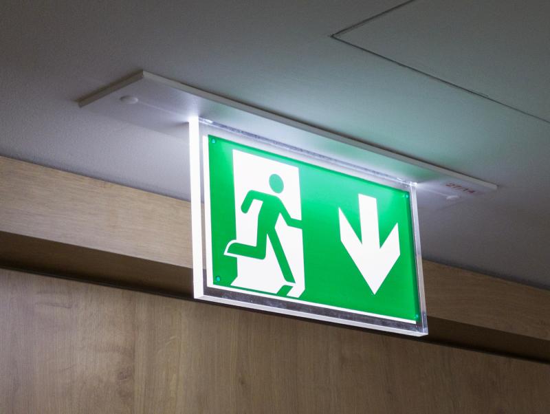 emergency fire exit sign hanging from the ceiling
