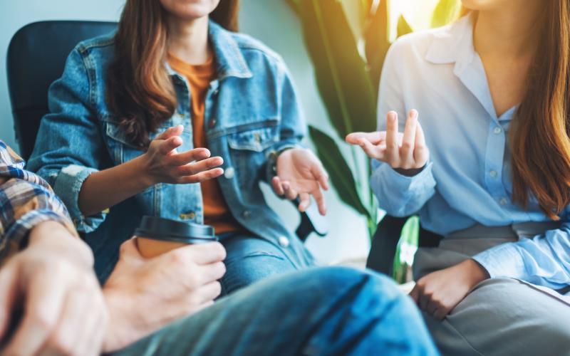 A group of young people sitting and talking together