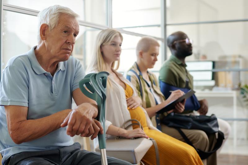 4 people queing in a medical clinic