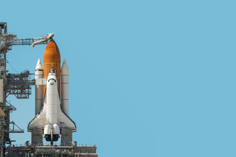 Space shuttle rocket isolated on blue cyan background with copy space. Elements of this image furnished by NASA.