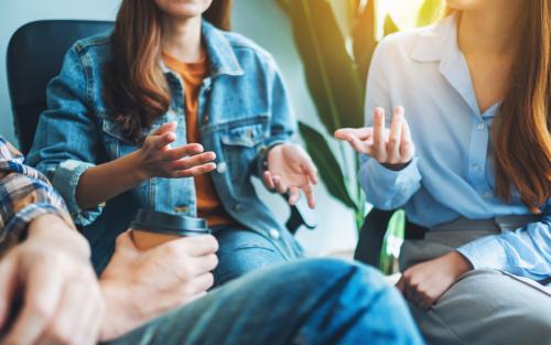 A group of young people sitting and talking together
