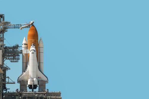 Space shuttle rocket isolated on blue cyan background with copy space. Elements of this image furnished by NASA.